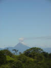 View of Arenal Volcano from Ciudad Quesada over tropical hardwood jungle